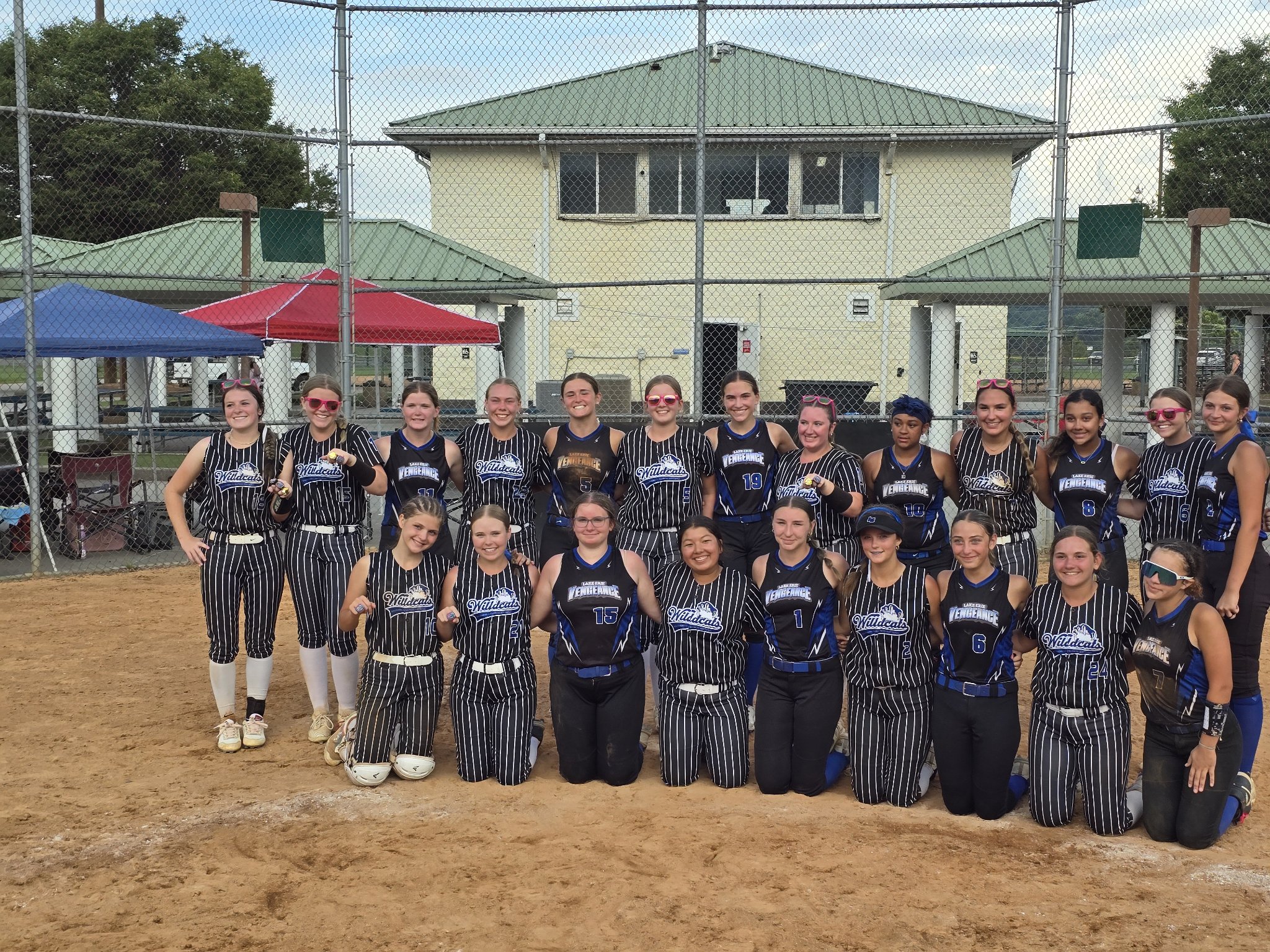 Lake Erie Vengeance players and an opposing team posing together on the softball field